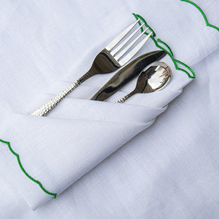 Casa Duniya's White Linen Placemat and Napkins with Green Scalloped Border and Chameli Hammered Silver Cutlery Set