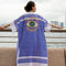 Casa Duniya's Hand-Painted Evil Eye Blue and White Beach Cover Up with Hong Kong Sklyline in the Background