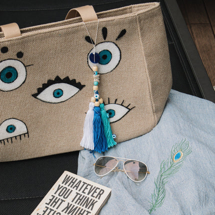 Casa Duniya's Hand-Painted Evil Eye Canvas Bag with Tassels, Embroidered Peacock Feather Robe and White Ray Ban Sunglasses