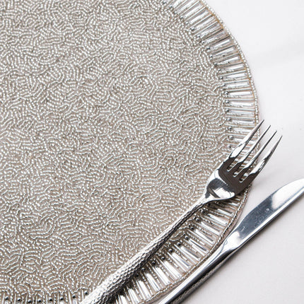 Casa Duniya's Sundara Silver Beaded Placemat with Hammered Silver Cutlery on a white Background