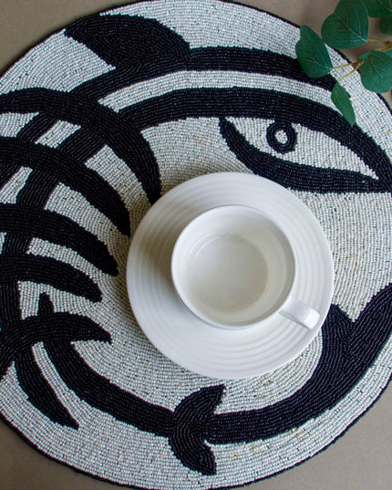 Round Placemat With Black Abstract Design With A White Up And Saucer